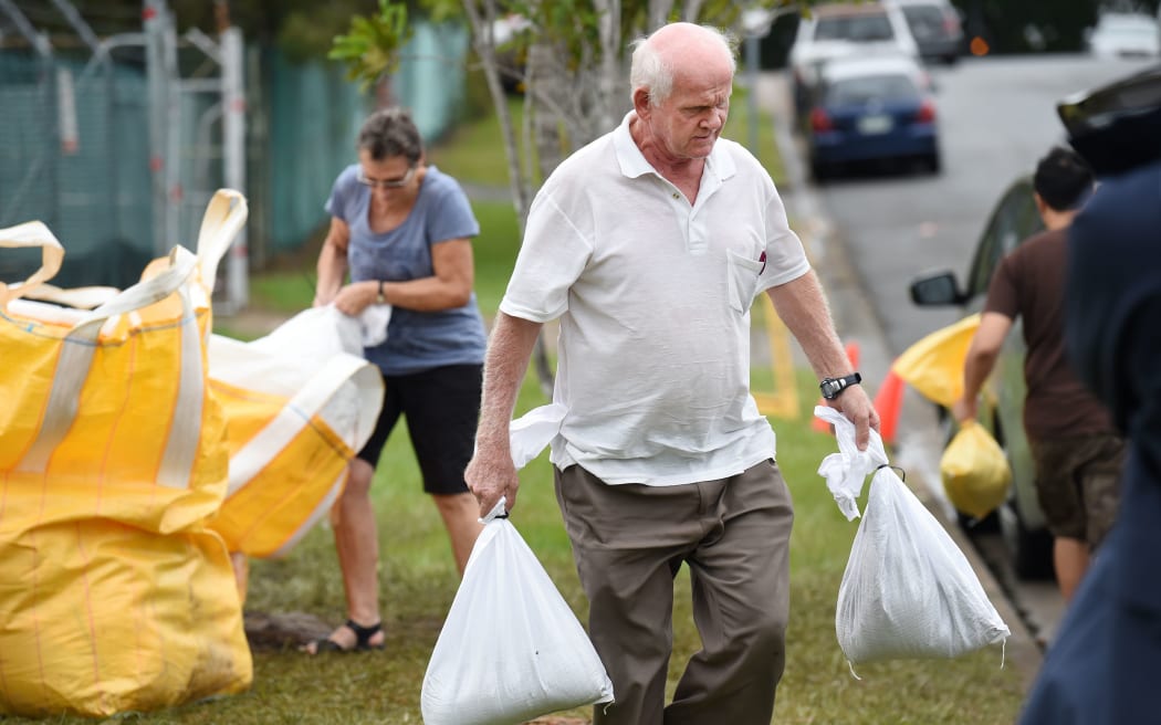 Brisbane residents prepare sandbags against rain forecast as Cyclone Marcia approaches.