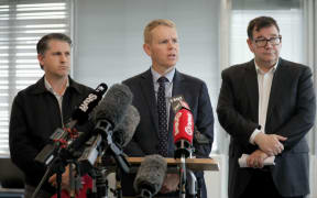 Prime Minister Chris Hipkins speaking in Māngere, Auckland, alongside Minister of Auckland Michael Wood, and Minister of Finance Grant Robertson after speaking to flood-affected businesses on 1 February, 2023.