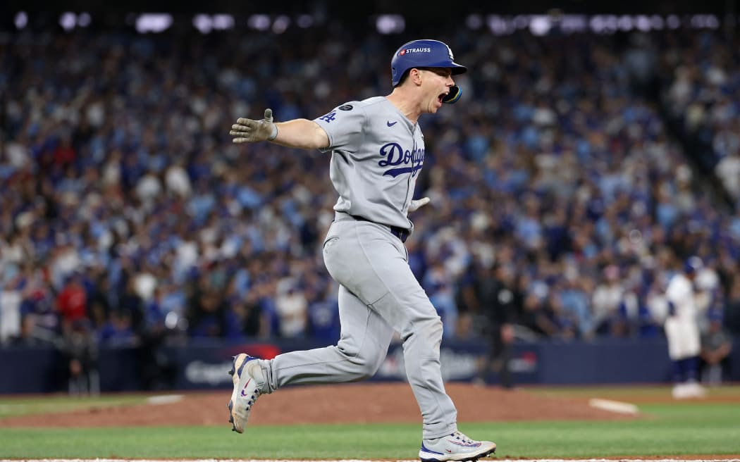 TORONTO, ONTARIO - NOVEMBER 02: Will Smith #16 of the Los Angeles Dodgers reacts after hitting a home run during the eleventh inning against the Toronto Blue Jays in game seven of the 2025 World Series at Rogers Center on November 02, 2025 in Toronto, Ontario.   Emilee Chinn/Getty Images/AFP (Photo by Emilee Chinn / GETTY IMAGES NORTH AMERICA / Getty Images via AFP)