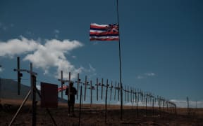 Crosses are attached by local residents to mourn the victims on a hill overlooking Lahaina, which has been devastated by wildfire.