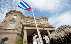 Cuban Foreign Minister Bruno Rodriguez (4th left) applauds after raising the Cuban flag over their new embassy in Washington, DC, 20 July  2015.