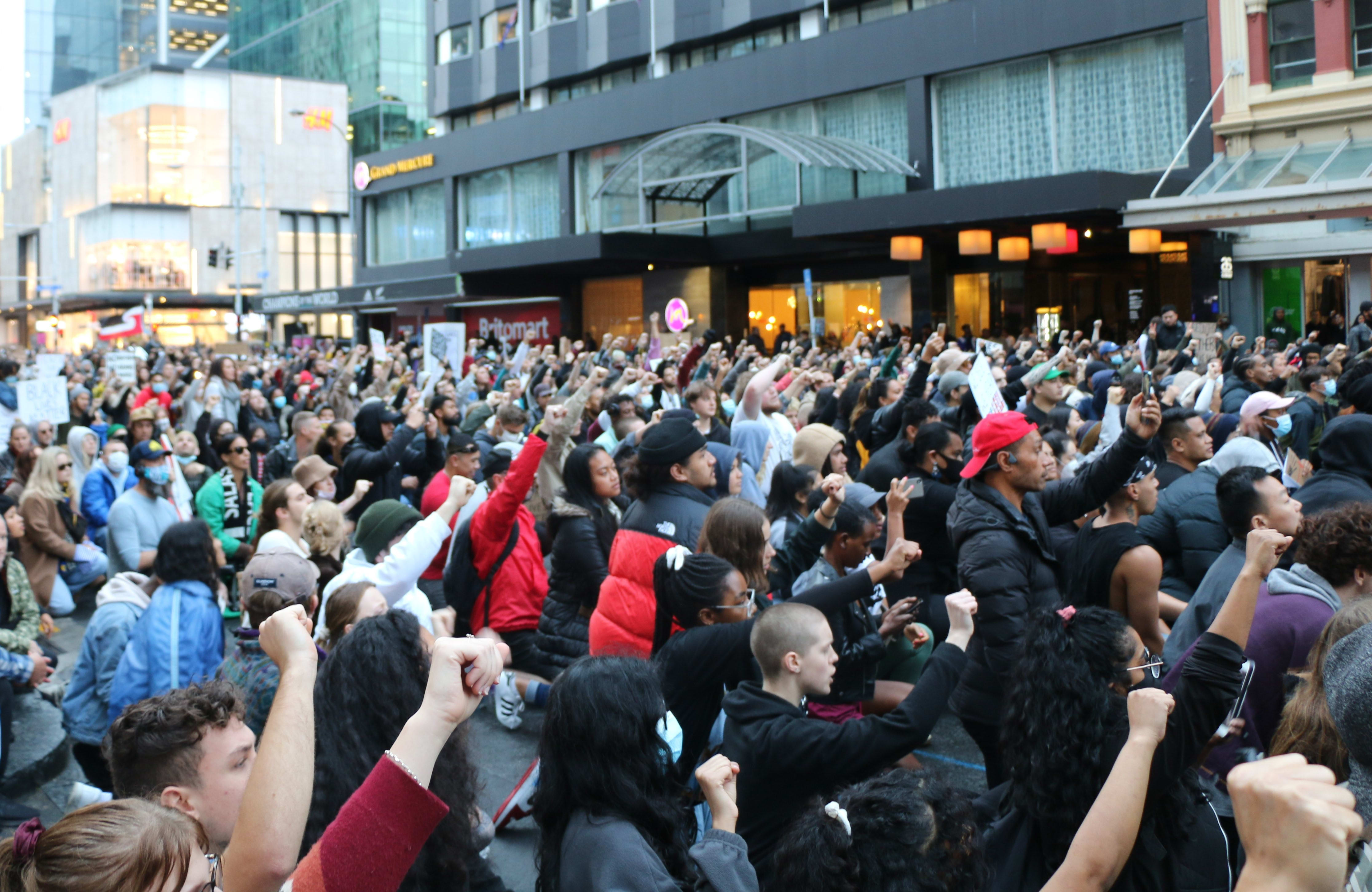 Protesters took a knee with fists up outside the US embassy building in Auckland on 1 June, 2020, chanting "Black lives matter".