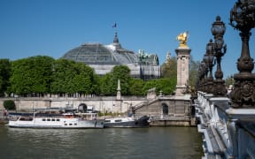 The Grand Palais seen from the Pont Alexandre III bridge over the Seine river in Paris.