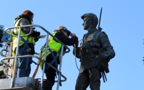 Art restoration team Carolina Izzo, right, and Maria Pagu at work on the cenotaph at Masterton's Queen Elizabeth Park