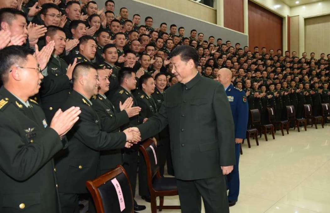 Chinese President Xi Jinping (R, front), also general secretary of the Communist Party of China (CPC) Central Committee and chairman of the Central Military Commission, meets with senior officers of the 71st Group Army of the People's Liberation Army.