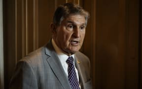 US Senator Joe Manchin (D-WV) talks to reporters as he leaves the Senate floor following a vote on 23 January, 2024 in Washington, DC.