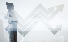 Businesswoman with chart arrows on wall. Financial growth concept