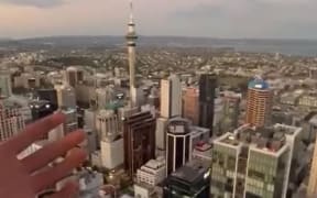 A screenshot from the TikTok video showing a person who said they were on the boom of a crane 220m above ground.