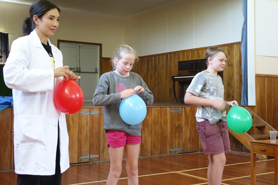 Nanogirl prepares a balloon experiment with Millie Denson, 10, and Jaden Allen 11