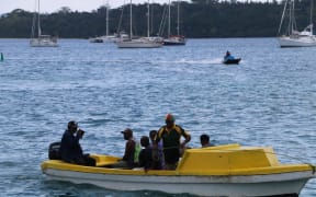 Port Vila generic - people at the seafront on a punt