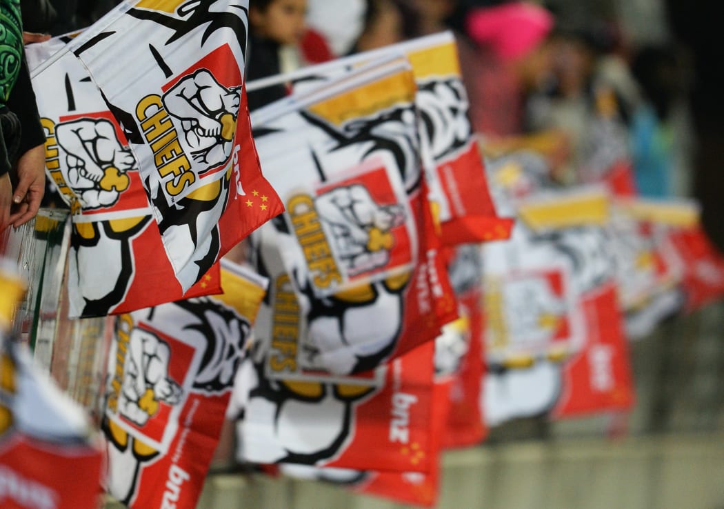 Flags are waved during a Chiefs vs Hurricanes game in 2013