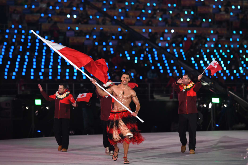 Tonga's flagbearer Pita Taufatofua leads his country's delegation.