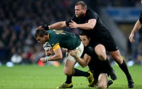 Handre Pollard of South Africa is tackled by Sonny Bill Williams