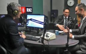 National's Dan Bidois shakes hands with Labour's Shanan Halbert at the end of their in-studio debate for the Northcote electorate.