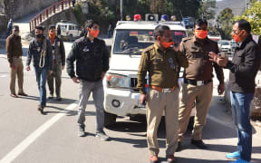 Police personnel prepare after a glacier broke off in India's Chamoli district causing flash floods in the Dhauli Ganga river