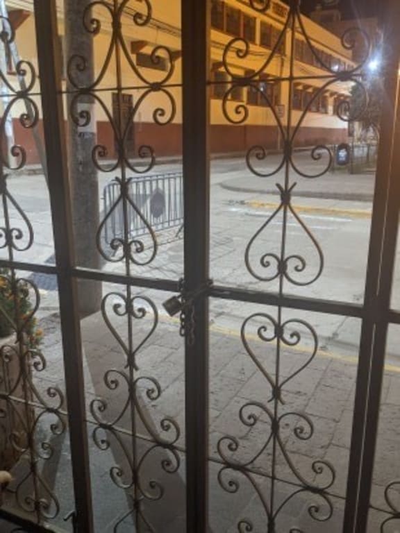 The doors of their hotel in Puno in Peru where Holly Bates and her partner Karl Damon are staying are chained shut and soldiers are stationed on every surrounding street.