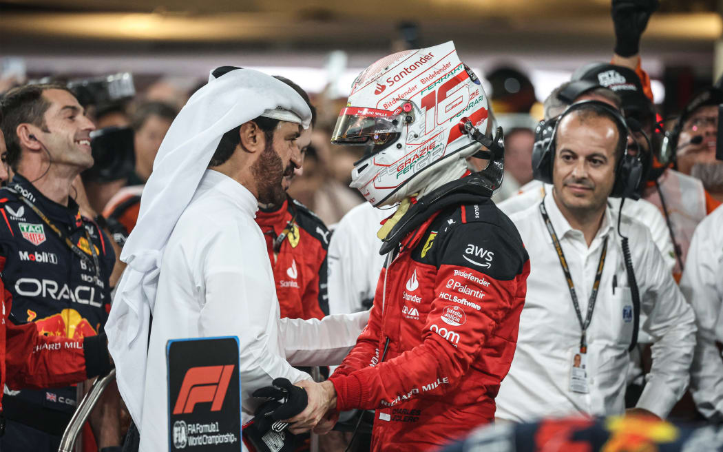 FIA president Mohammed Ben Sulayem (L) congratulates Ferrari driver Charles Leclerc.