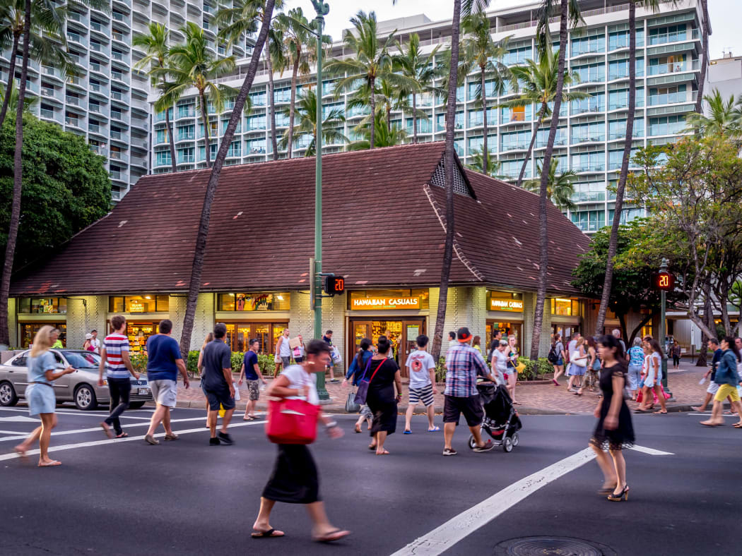 Busy intersection on Kalakaua Avenue on April 27, 2014 in Waikiki, Hawaii Kalakaua Avenue is the favorite luxury shopping strip for tourists visiting Hawaii