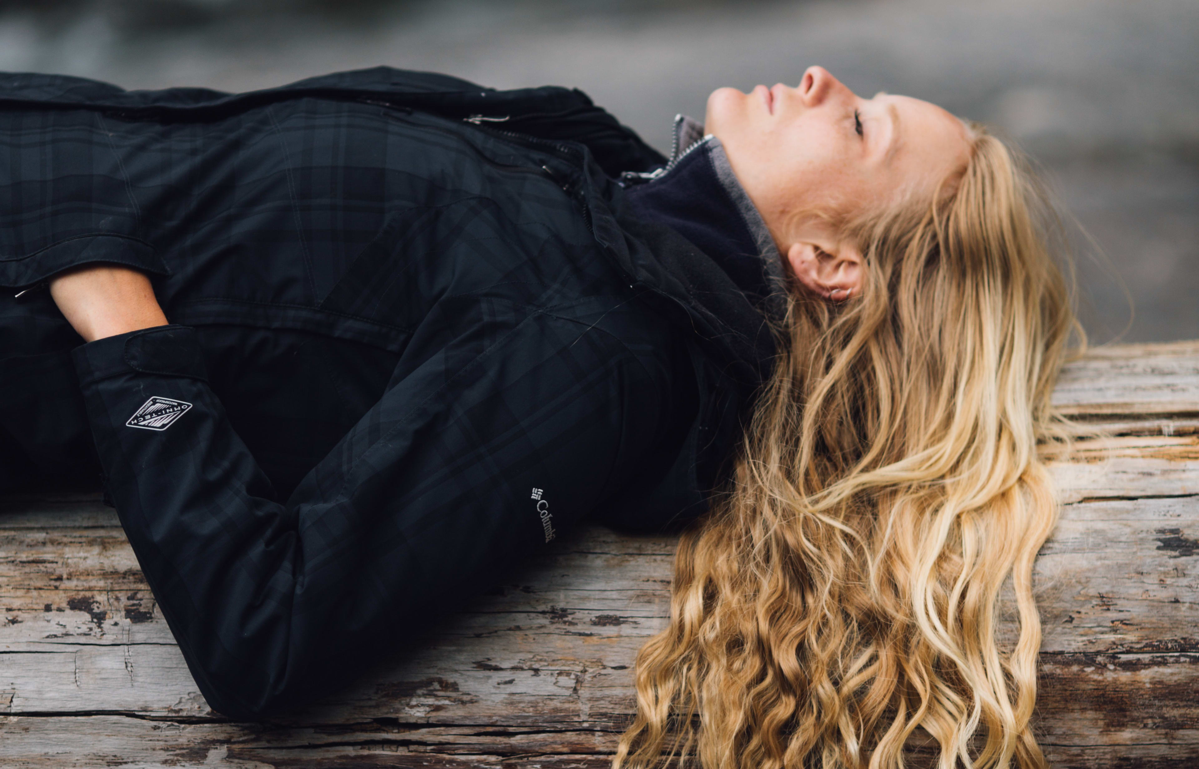 woman resting on log