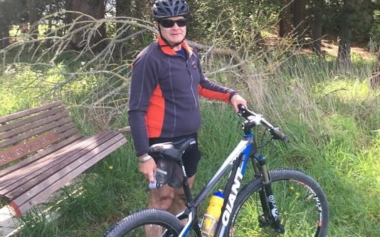 A man next to a bike.
