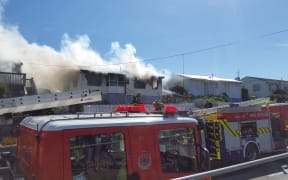 Smoke pours from a house on Te Pene Avenue, Titahi Bay.