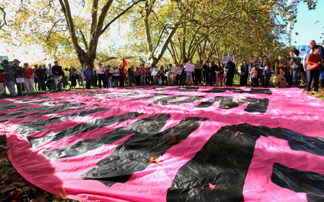 Climate advocates take part on a march in Auckland on 26 May, 2023, demanding New Zealand reduces its emissions, transition to regenerative agriculture, lower the voting age to 16 and respond to the climate crisis with tangata whenua at the center of decision making.