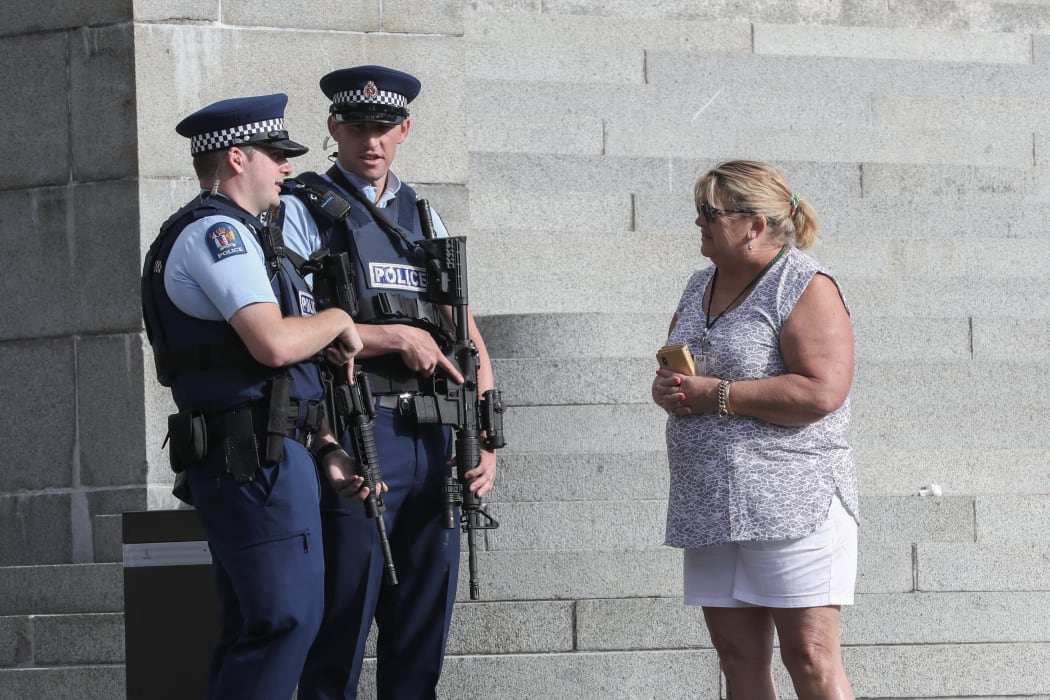 Armed police chat with a visitor to Parliament
