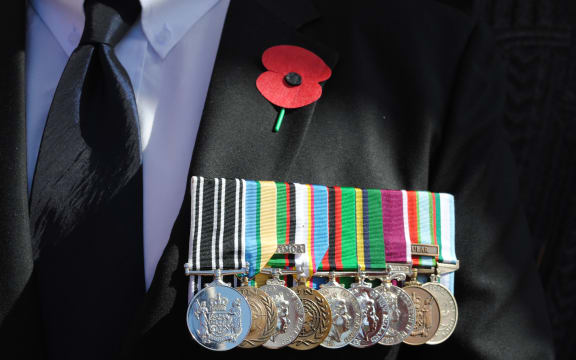 Remembrance poppy and medals on a veteran at the 50th commemoration of the Vietnam War held at Pukeahu National War Memorial, Wellington, in August.