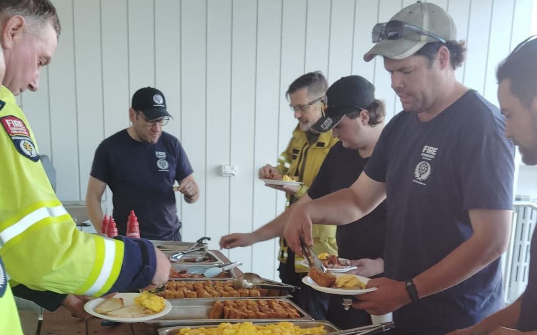 Firefighters take a break in Kaikōura on Friday morning.