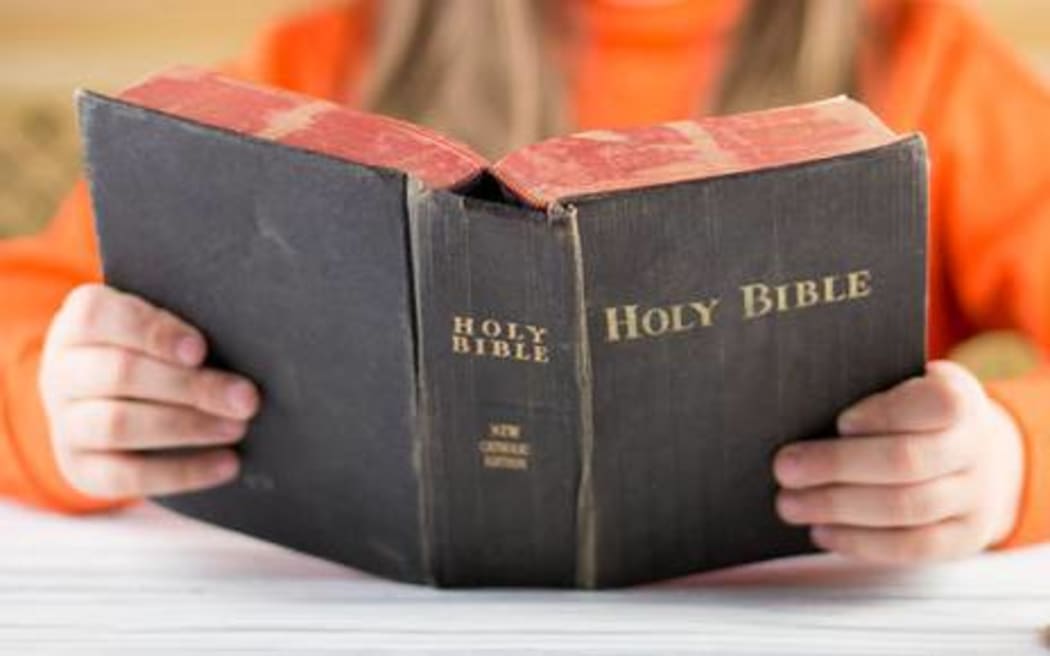 Girl holding bible