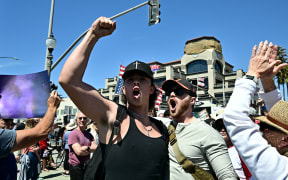 Protestors gather during a 'Hands Off!' protest against the policies of US President Donald Trump and his advisor, Tesla CEO Elon Musk, in Huntington Beach, California, on April 5, 2025.