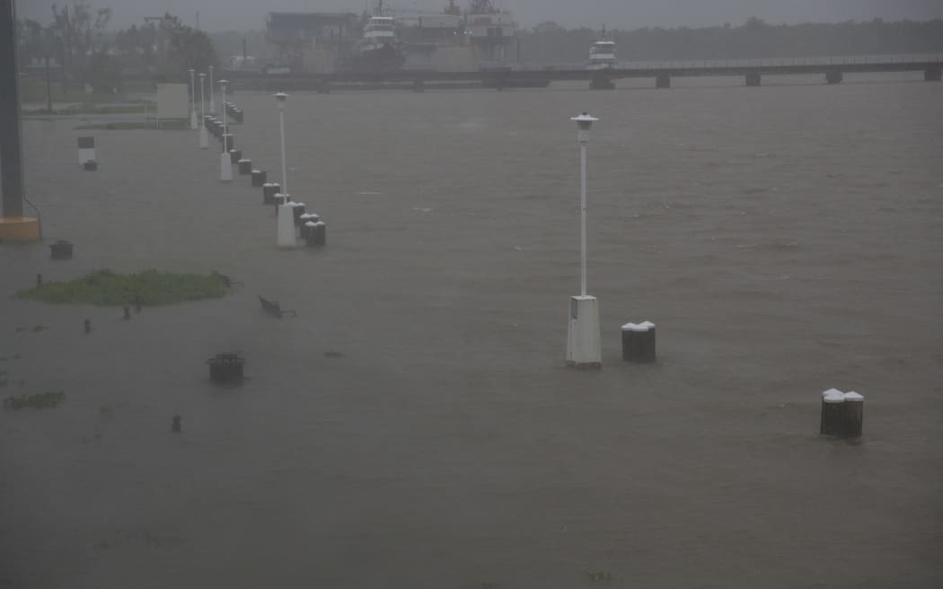 Benches and walkways are flooded by water along the Berwick River in Morgan City, Louisiana ahead of Tropical Storm Barry Saturday, July 13,2019.