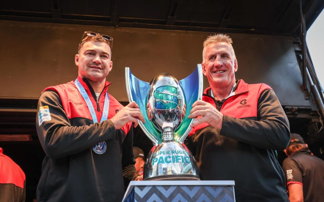 Crusaders captain David Havili and Head Coach Rob Penney stand with the Super Rugby Trophy.