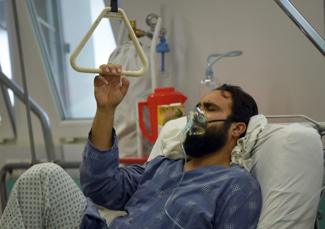 A wounded staff member of Doctors Without Borders (MSF), survivor of the US airstrikes on the MSF Hospital in Kunduz, receives treatment at an Italian aid organisation.