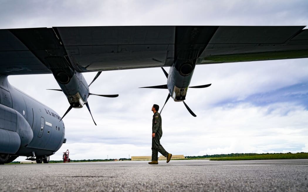 US Air Force Captain Chris Gullo conducts an inspection of a C-130J Super Hercules at Andersen Air Force Base, Guam before last year's mission to deliver goods to the Pacific