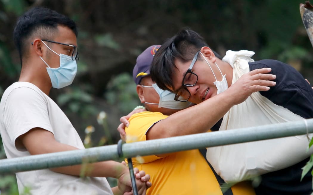 About a hundred people take part in a memorial ceremony in Hualien, Taiwan, on 3 April 2021, mourning the train derailment deaths, killing at least 50, and injuring dozens in a tunnel on 2 April.