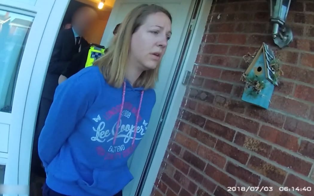 A handout image taken from police bodycam footage released by Cheshire Constabulary police force in Manchester on August 17, 2023, shows the nurse Lucy Letby being arrested at home in Chester on July 3, 2018. Lucy Letby was on August 18, 2023, found guilty of murdering seven newborn babies and trying to murder six others at the hospital neonatal unit where she worked, becoming the UK's most prolific killer of children. Letby, 33 -- on trial since October 2022 -- was accused of injecting her young victims, who were either sick or born prematurely, with air, overfeeding them milk and poisoning them with insulin. (Photo by Cheshire Constabulary / AFP) / RESTRICTED TO EDITORIAL USE - MANDATORY CREDIT  " AFP PHOTO / CHESHIRE CONSTABULARY/ HANDOUT "  -  NO MARKETING NO ADVERTISING CAMPAIGNS   -   DISTRIBUTED AS A SERVICE TO CLIENTS  - RESTRICTED TO EDITORIAL USE - MANDATORY CREDIT  " AFP PHOTO / Cheshire Constabulary/ Handout "  -  NO MARKETING NO ADVERTISING CAMPAIGNS   -   DISTRIBUTED AS A SERVICE TO CLIENTS /