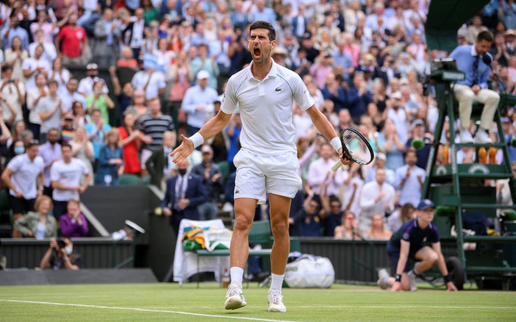 Serbia's Novak Djokovic celebrates beating Canada's Denis Shapovalov in their men's singles semi-final match on the eleventh day of the 2021 Wimbledon Championships at The All England Tennis Club in Wimbledon, southwest London, on July 9, 2021.