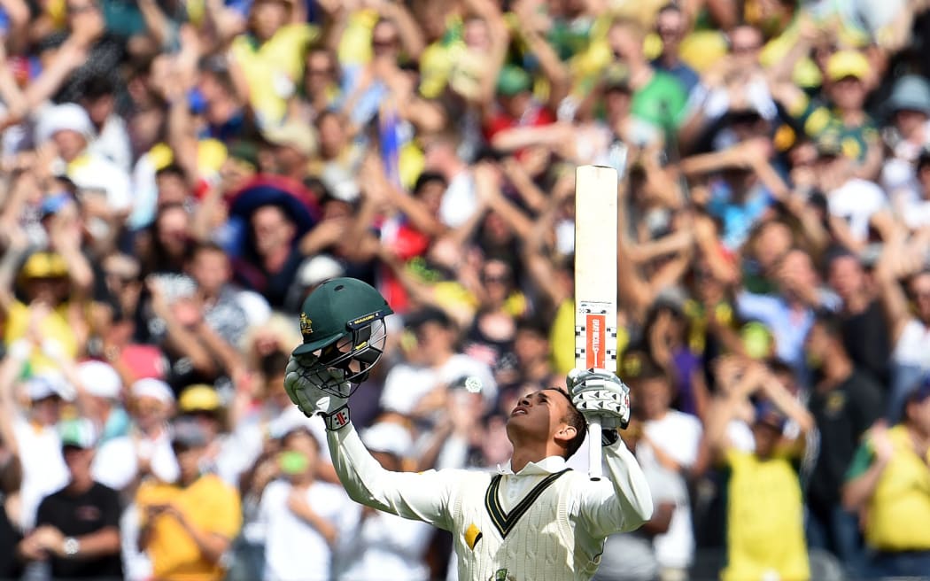 Australian batsman Usman Khawaja celebrates scoring his century against the West Indies