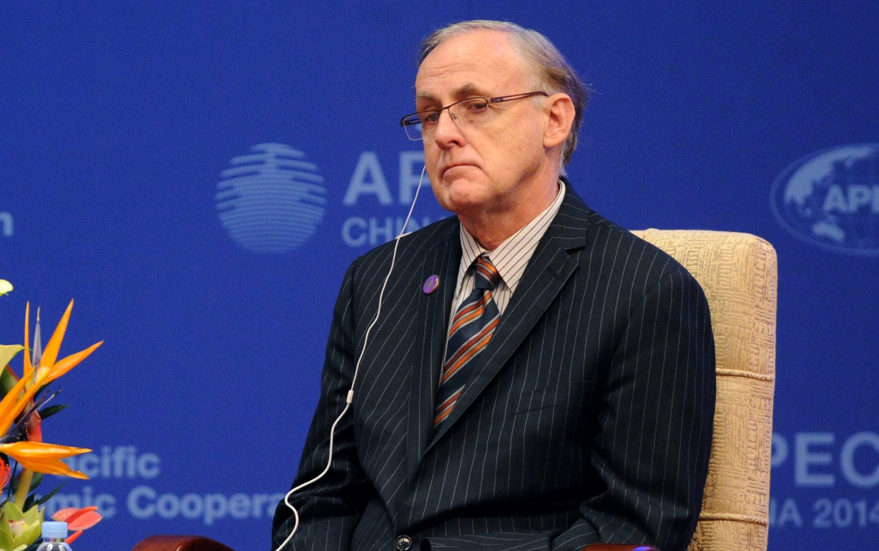 Alan Bollard listens as he attends the opening ceremony of the Asia-Pacific Economic Cooperation (APEC)  finance ministers's meeting in Beijing, October 2014.