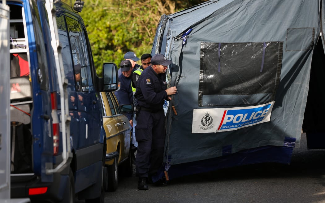Police moving the forensic tent in the cordon down Broderick Cresent.