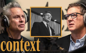 Guyon Espiner is wearing headphones positioned on the left of the image looking to the right. Corin Dann is wearing headphones on the right of the image looking towards the left. In the middle of the image is a yellow square featuring a black and white photo of Jim Bolger. In the bottom left hand corner is the logo for the podcast series 'Context' in mustard yellow.