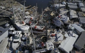 In this aerial view, boats sit atop one another in a marina near Fort Myers Beach on 29 September, 2022 in San Carlos Island, Florida.