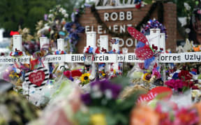 Crosses surrounded by flowers and other items are seen at a memorial on Thursday, 9 June, 2022, for the victims of a shooting at Robb Elementary School in Uvalde, Texas. Friday, 24 May, 2024 marked the two-year anniversary of the shooting, where a gunman killed 19 students and two teachers.