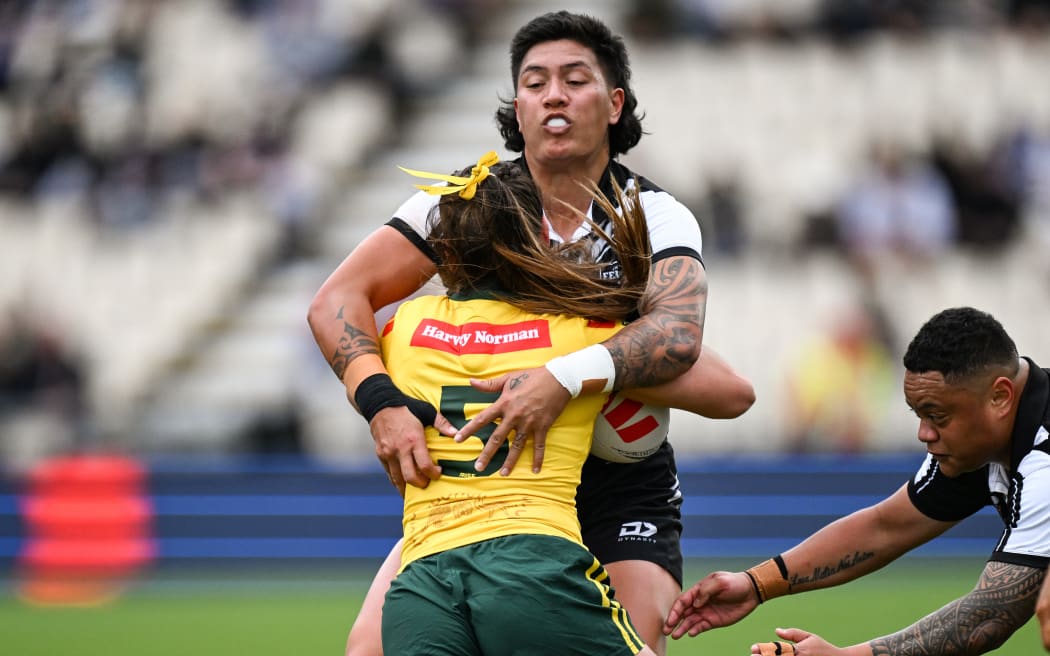 Gayle Broughton of New Zealand tackles Jakiya Whitfeld of Australia.