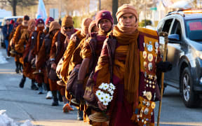 Led by Bhikkhu Pannakara (R), Buddhist monks participate in a "Walk for Peace" in Richmond, Virginia, on February 3, 2026. The group is walking from Fort Worth, Texas, to Washington, DC to promote peace, compassion and nonviolence. (Photo by Aaron Mathes / AFP)
