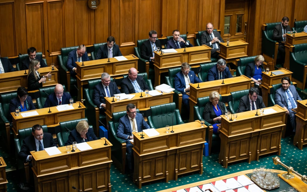 Opposition MPs read through budget documents, take notes, and prepare responses while listening to the Minister of Finance deliver their Budget 2021 statement
