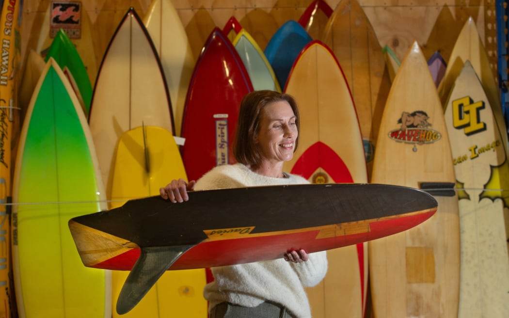 Tauranga museum curator Fiona Kean with Dusty Waddell’s collection of 130 Kiwi surfboards.