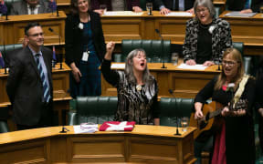 Departing Green MP Catherine Delahunty sings with her colleagues in the House after her valedictory speech.