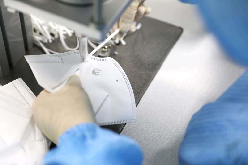 A worker produces medical N95 masks at a mask production company in Shenyang, China, on February 8, 2020.